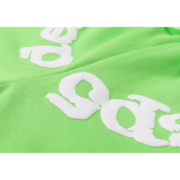 Close-up view of the white high-quality print detail on the green Sp5der Websuit sweatpants for streetwear fashion.