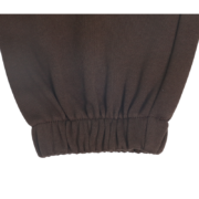Close-up view of the elasticated ribbed ankle cuff on the premium dark brown Sp5der 555 555 sweatpants for men and women.