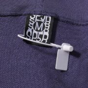 Close-up view of the branded tag on the Navy-Blue Sp5der Beluga sweatpants, highlighting the quality and authenticity.