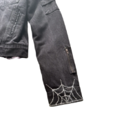 Sp5der Worldwide black denim jacket featuring a distinctive rhinestone spider web detail on the sleeve for streetwear.