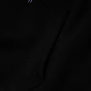 Close-up view of the black kangaroo pocket detail on a Sp5der Worldwide Web Hoodie for a sleek urban streetwear look.