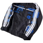 Black and blue Sp5der satin bomber jacket featuring a classic silhouette, white striped sleeves, and graphic logos.