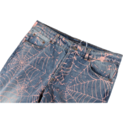 Detailed view of the Sp5der AOP Vintage 501 denim jeans featuring an all-over pink web print and waist detail.