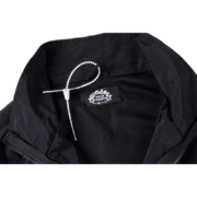 Close-up of the Sp5der Pro Windbreaker interior label and mesh fabric, confirming authentic brand design.