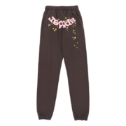 Front view of brown Sp5der OG Web sweatpants featuring pink branding and yellow star print on premium fabric.