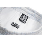 Detailed interior label view of the Sp5der AOP Web Sweatpants in Heather Grey featuring size M branding and logo.