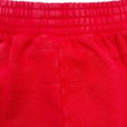 Close up shot of the premium red fabric texture on the iconic Sp5der OG Logo sweatshort for streetwear style.