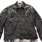 Sp5der Worldwide black denim jacket featuring a distinctive rhinestone spider web detail across the shoulders.