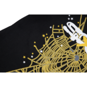 Close-up of the SP5DER Web Print Gothic Punk T-Shirt featuring an intricate gold web and star graphic design.