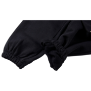 Close up view of the elasticated hem detail on the black Sp5der Souvenir SP5 sweatpants for a premium loose fit.