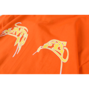 Close-up of the bright orange Sp5der Arach t-shirt featuring stylized yellow and white urban streetwear graphic detailing.