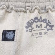 Close-up view of the inner size tag and brand logo details inside the Sp5der OG Web Logo premium French Terry sweat short.