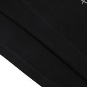 Close-up view of the high-quality black fabric and detailed stitching on the Sp5der Black 55555 Spider Web T-shirt.