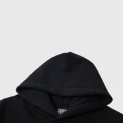 A detailed close-up of the black Sp5der Jeffery hoodie hood, highlighting the quality fabric and inner brand label.