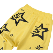 Yellow Sp5der 5Star sweatpants featuring a vibrant colorway and bold black star graphic detailing for streetwear style.