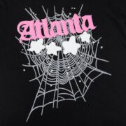 Sp5der Atlanta Print T-Shirt in black featuring a pink logo and a graphic spider web design with white stars.