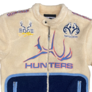 Front view of the off-white Sp5der Worldwide Hunters Sherpa Moto Jacket with embroidered logo and navy blue trim.