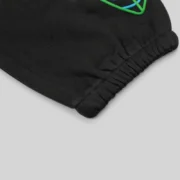 Close-up detail of the black Juice WRLD 999 x SP5DER Worldwide 555 sweatpants showing premium fleece cotton fabric.