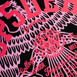 A close-up view of the vibrant pink eagle and Atlanta Track & Field graphic on the Sp5der Cross Country Slub Tee.
