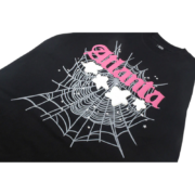 Sp5der Atlanta black t-shirt featuring a pink graphic print with spider web and star details, front view product shot.