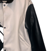 Close-up view of the Roam The Halls Sp5der Jacket featuring a premium black and white color-blocked leather design.