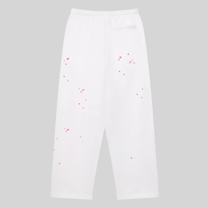 Back view of white SP5DER Fractured Logo wide leg sweatpants featuring scattered pink star print graphics.