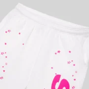 Close-up of white SP5DER fractured logo sweatpants with pink graphic star details on French terry fabric