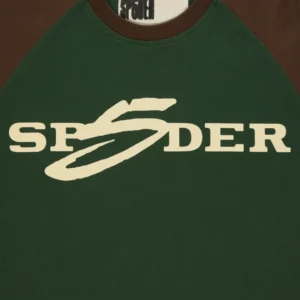 Close-up view of the green Sp5der 5uki Tee showing the iconic white Sp5der graphic print on the front of the garment.