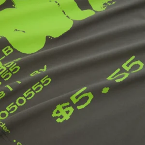 Close-up view of the Sp5der Commerce Tee showing a grey cotton fabric with vibrant neon green graphic print details.