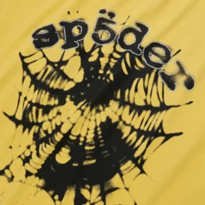 Sp5der Scattered OG Web V2 yellow tee close-up showing black spiderweb graphic and rhinestone-lined SP5DER text on cotton