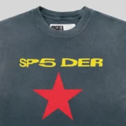 Close up of the Sp5der FIVE POINT Tee featuring a black faded wash with yellow SP5DER logo text and a red star print.