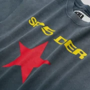 A close-up view of the charcoal gray Sp5der FIVE POINT T-shirt featuring yellow branding and a bold red star graphic.