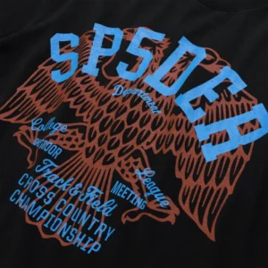 Close-up view of the black Sp5der Champions League graphic cotton tee with blue and brown stylized eagle print.