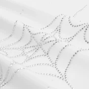 A close-up detail shot of the rhinestone embellished spider web graphic on the Sp5der Rhinestone Silk Tee white shirt.