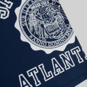 Close-up view of the Sp5der Academy Rugby Navy shirt showing the signature white graphic logo print on the front chest.