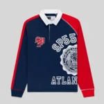 Front view of the Navy Sp5der Academy Rugby long-sleeve shirt with red sleeves and white logo graphics.
