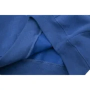 Close-up view of the premium cotton fabric and texture on the navy-blue Sp5der Acai Hoodie, showcasing quality design.