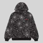 Front view of the black Sp5der All Over Print Hoodie with a white embroidered web design and chest logo detail.