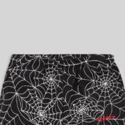 A close-up view of black Sp5der sweatpants featuring an embroidered white all-over web design and a signature logo.
