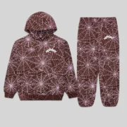 Sp5der brown all-over print tracksuit featuring an embroidered web design on a hoodie and matching sweatpants.