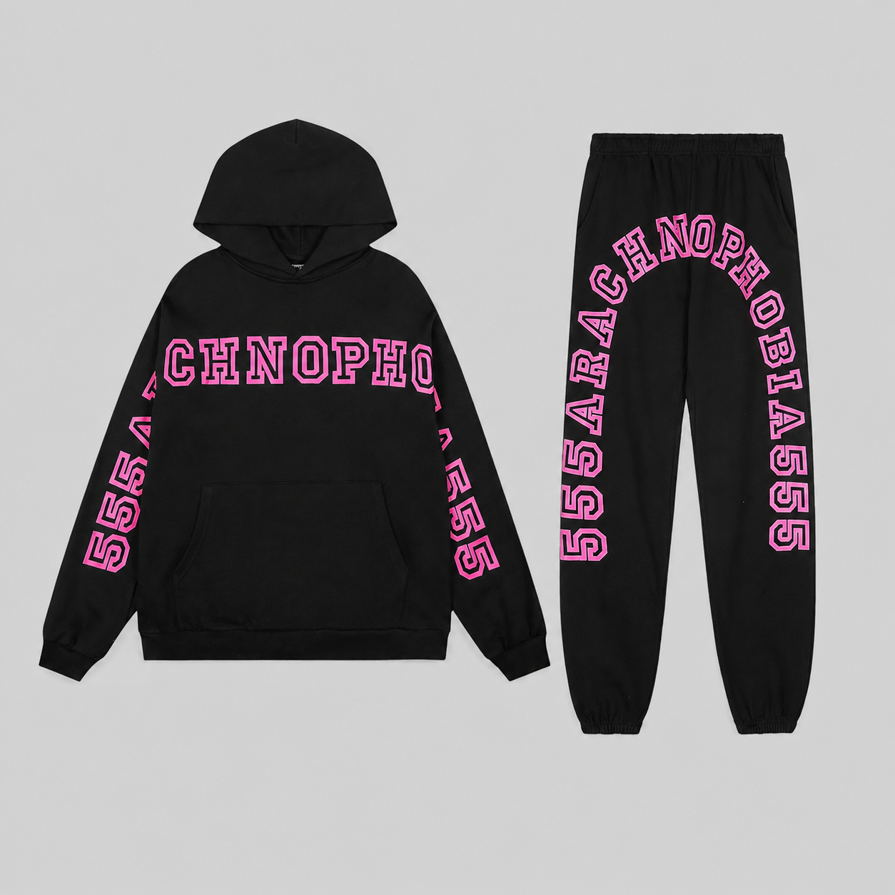 Sp5der Arach Tracksuit in black featuring pink graphic arched puff print lettering, a premium 100% cotton fleece set.