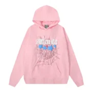 Front view of the premium Baby-Pink Sp5der Atlanta hoodie featuring a loose fit and signature distressed web print.