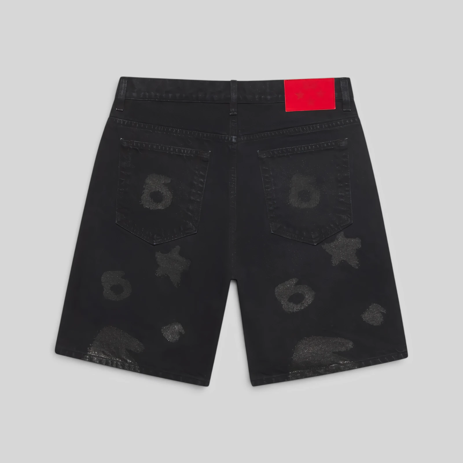 Back view of Sp5der Beluga denim shorts in black featuring signature all-over faded print and leather branded waistband.