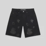 Front view of the black Sp5der Beluga denim shorts featuring signature star and spider print design details.