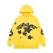 Front view of the vibrant yellow Sp5der Beluga Hoodie featuring black logo and star graphics with a loose fit design.