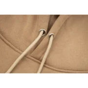 Close-up view of the drawstring and fabric detail on the premium light-brown Sp5der Beluga Hoodie for men and women.