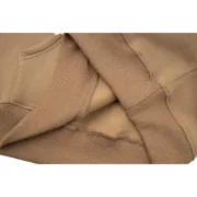 A detailed close-up look at the premium cotton and polyester fabric texture of the Sp5der Beluga Hoodie in Light-Brown.