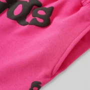 Close-up view of the Sp5der Beluga Sweatshorts in pink featuring signature graphic branding and premium cotton fabric.