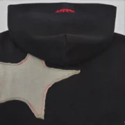Close-up view of the black Sp5der Big Star full zip hoodie featuring a distinctive frayed star patch and branding.