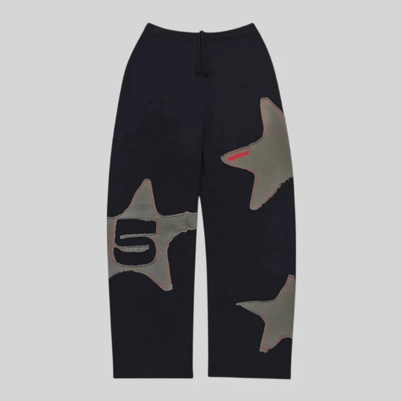 Front view of Sp5der Big Star Black Wide Leg Sweatpants made from heavy 13oz cotton fleece with frayed star patches.